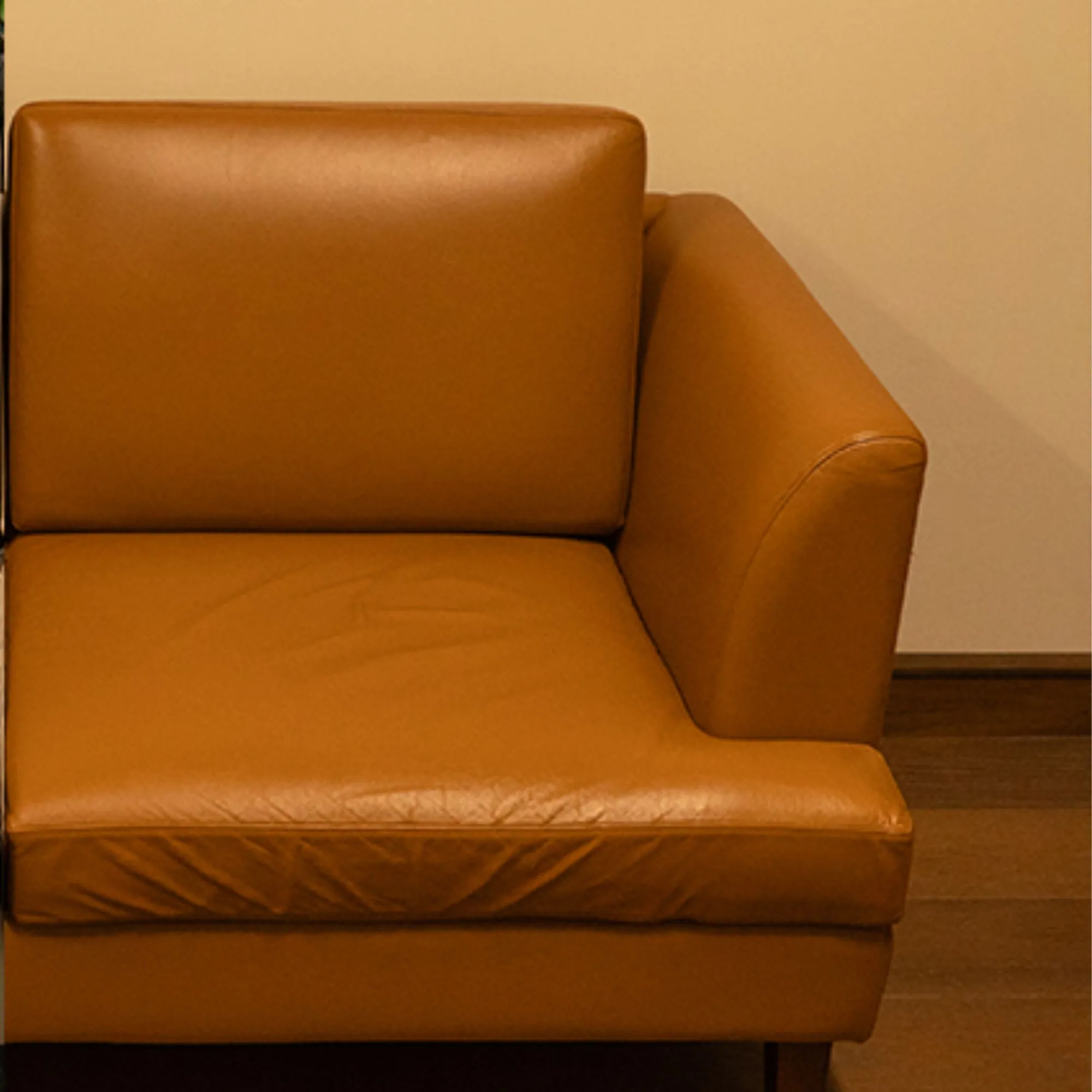 Leather sofa before repair — cuts and worn leather