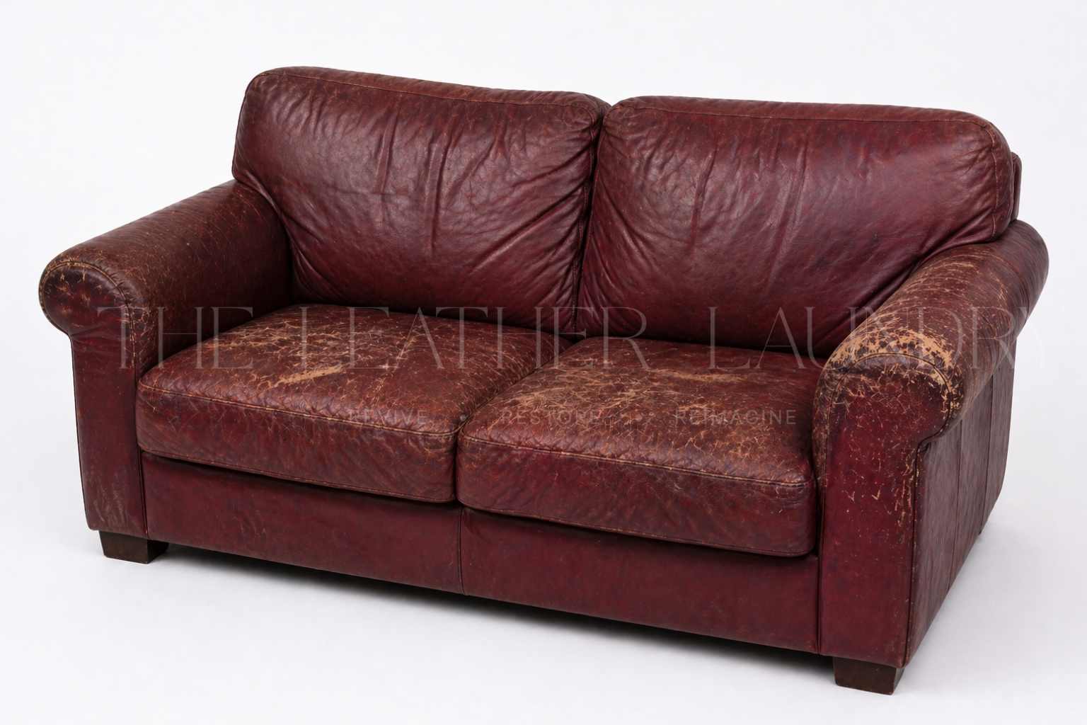 Leather sofa before colour restoration — faded and discoloured