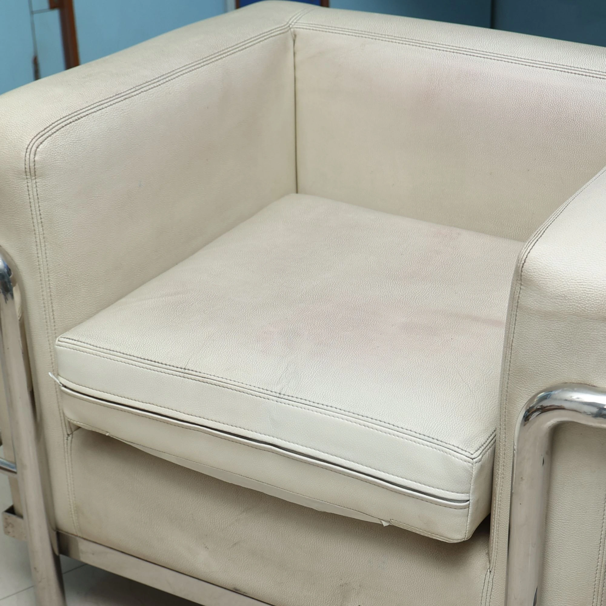 Leather sofa before repair — severe peeling and surface damage